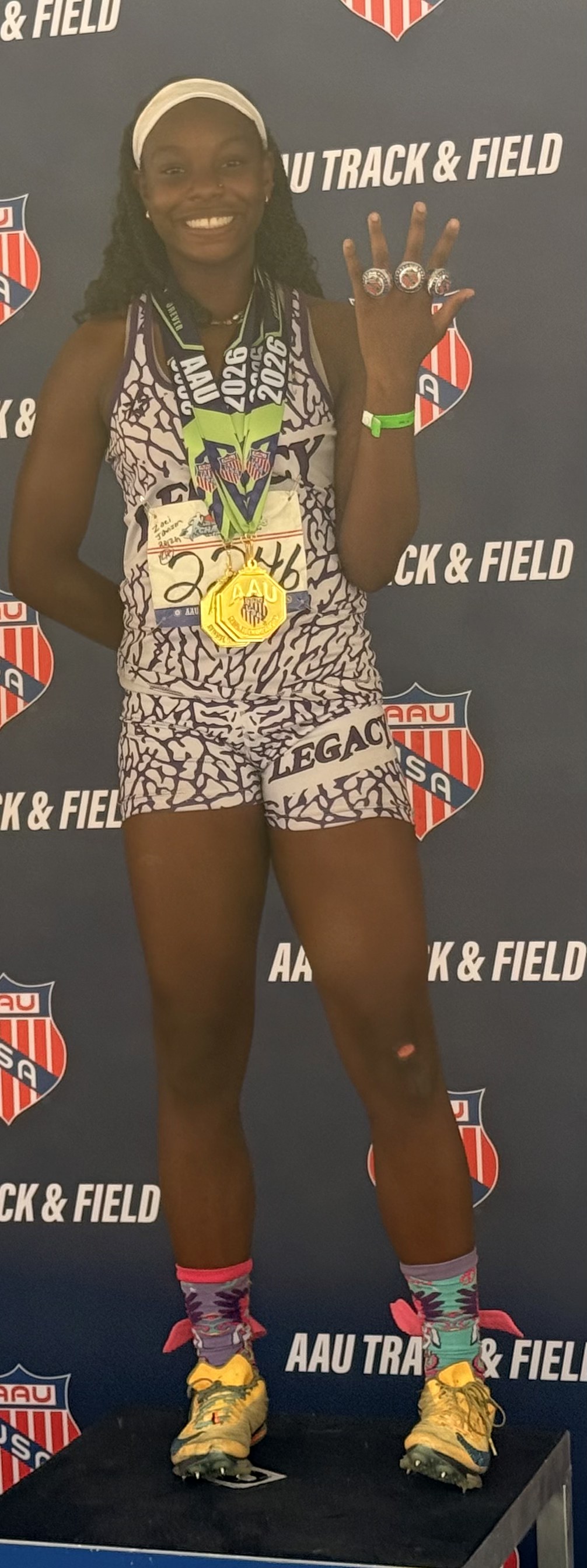 Zoei Johnson at AAU Track & Field Club Championships with four national title rings